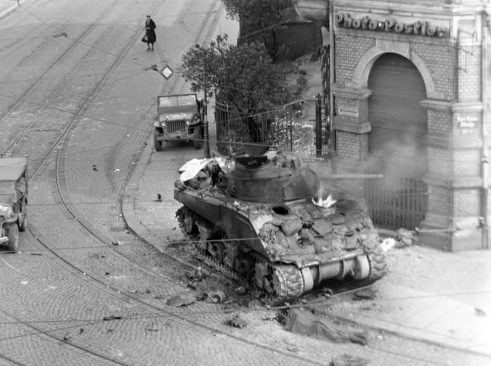 Sherman tank on fight in the streets of Aachen Germany 1945, they were so lightly armored most German anti-tank weapons easily pierced their armor. German hand held anti-tank weapons such as the Panzer-Faust proved deadly to Allied tank crews.