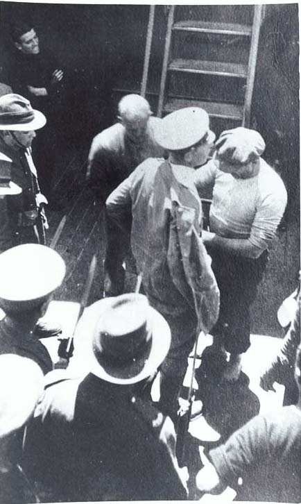 WW1: Luckner being searched on Iris after being recaptured after escaping from an internment camp in December 1917.