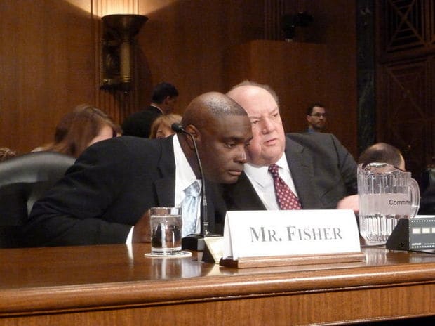 Glenville native Antwone Fisher, whose autobiography was made into a Hollywood film directed by Denzel Washington, chats with another witness at a Senate Finance