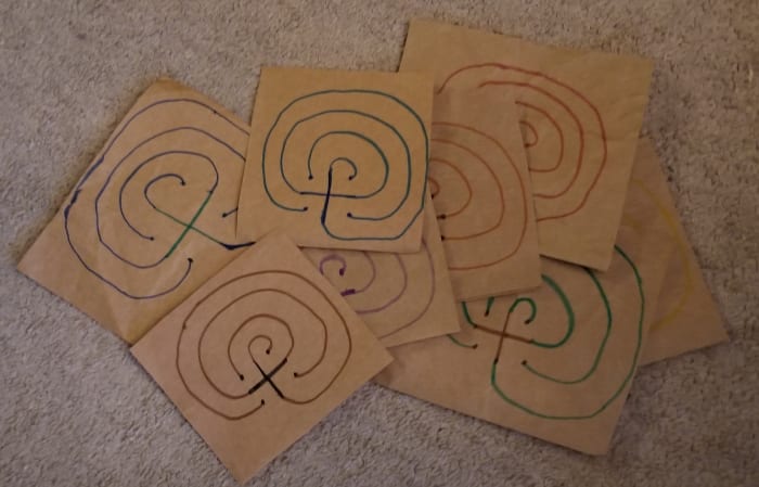 Make a bunch of finger labyrinths to walk and write on from journal prompts, then bind all of the ones you created for one project together as a record of your creative process for that project. They can serve as companions to your writing journal.