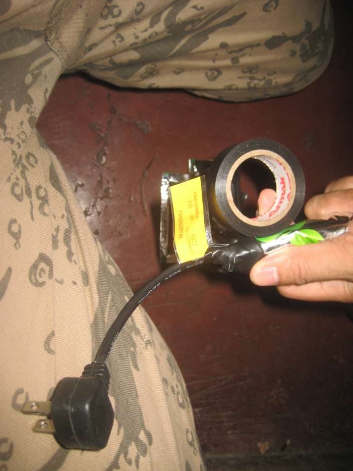 3. Place the cord (with 3 inches allowance from the plug) between the punctured part of the sachet. Seal tightly with electrical tape.
