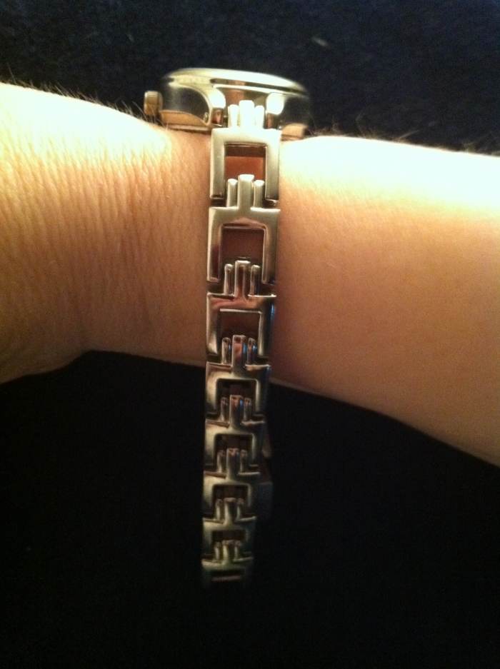 Figure 1. The Bracelet is Laying Loosely Around Your Wrist, Pressed Up Against a Soft Surface Such as Furniture