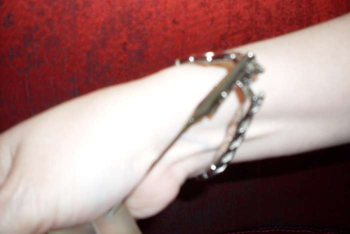 Figure 4. With the help of the alligator clip holding one end stationary, carefully close the clasp of the jewelry.