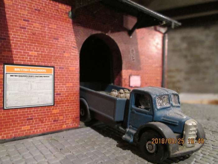 A lorry has backed in to the goods shed - notice beside the arched doorway warns of impending closure