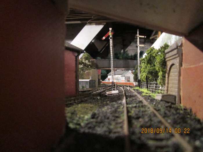 View down the tracks with the platform road free - seen from under the public (narrow) bridge