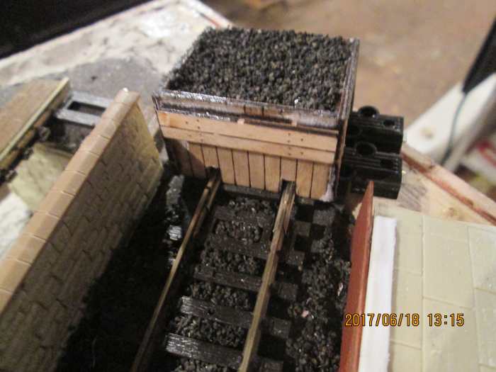 Poppy's Woodtech sleeper-built buffer stop with cinder ballast topping seen from the platform side, the buffer stop still to be secured and durable enough to withstand transit.