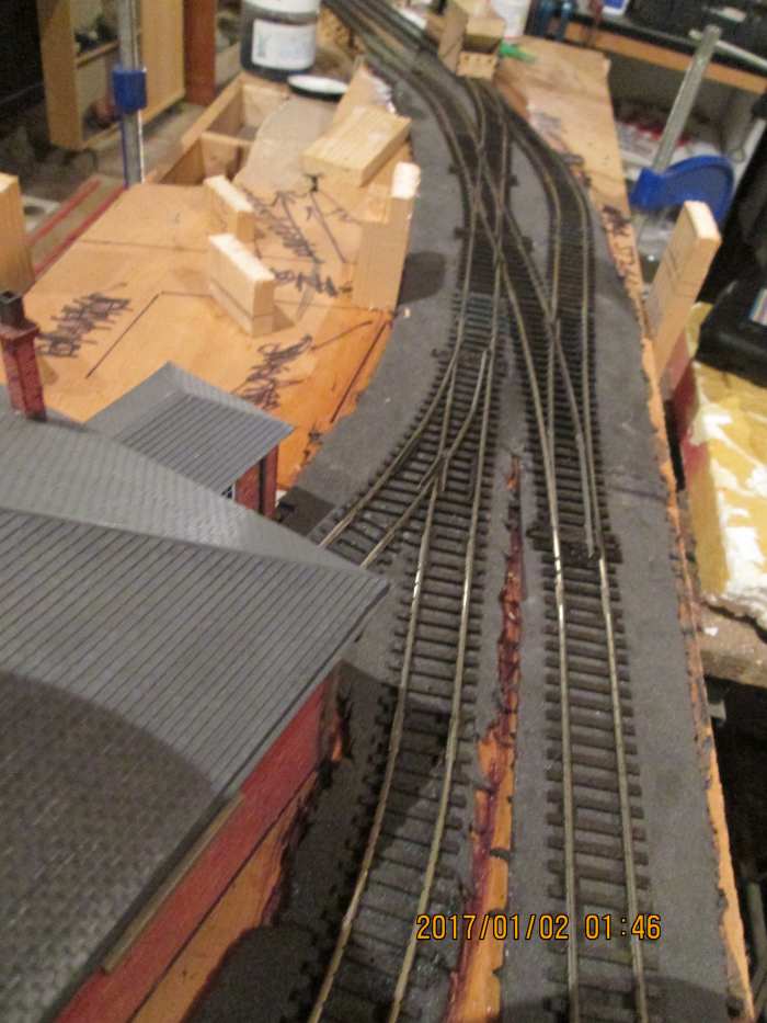 Trackwork adjusted by inserting a large radius Peco Streamline 'Y' point where the right-hand No.2 radius point was. Single slip reversed to ease passage of pick-up goods locomotive around its short train..