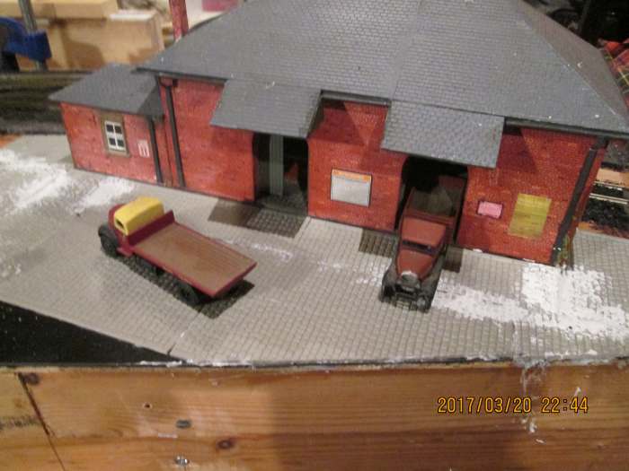The goods shed's been secured in place, granite sets added to front. A connecting road needs to be laid in to the coal depot under the access road via a tunnel. Front 'bleeds off' the layout.