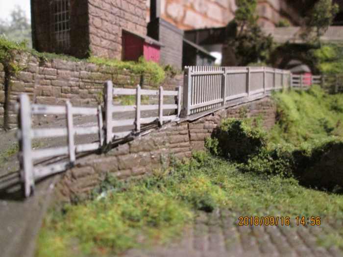 The ramp up from the coal depot has been given some white-painted safety fencing. The difference in fencing styles on the slope is to show the effects of the wartime blackout - drivers hitting the fence in the dark