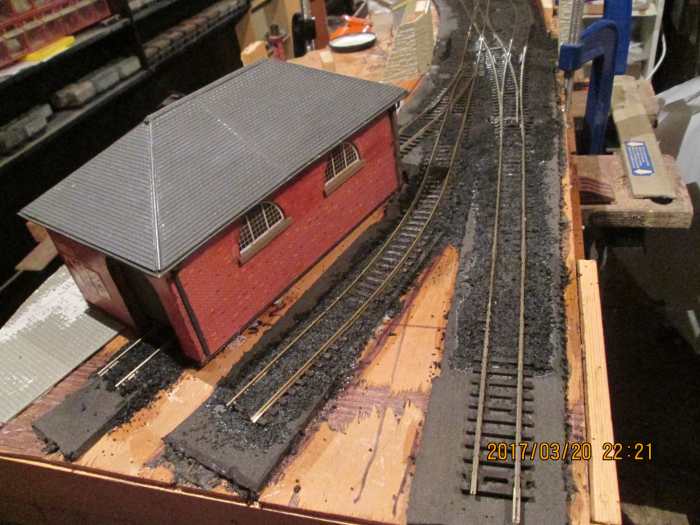 The track on the right will be covered by another road after the Peco power clips have been added, and 'bled off' to fiddle yard. Centre is the wagon headshunt, left the 'stub' at the goods shed's back door.