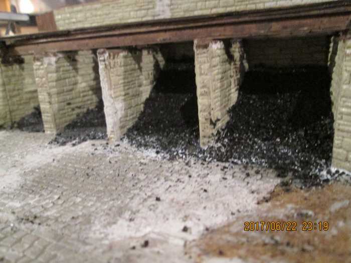 The plastic slopes have been covered with real coal - still some left after all this time, from the lump I took from a small pile at North Woolwich Station (down the road from Silvertown and the Thames Barrier). All that needs adding is the hand rail