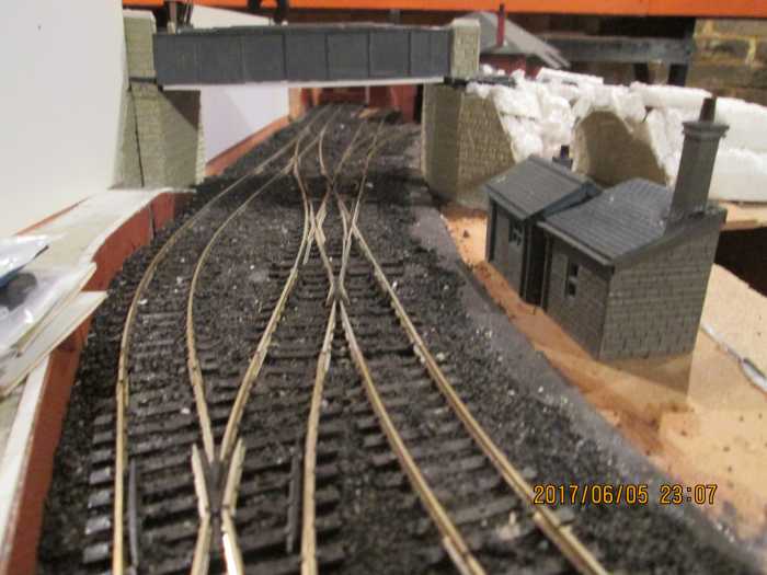 Things are looking up. Notice the white plastic sheeting against the back wall. This is where sheets of 1D self-adhesive printed scenery will be mounted