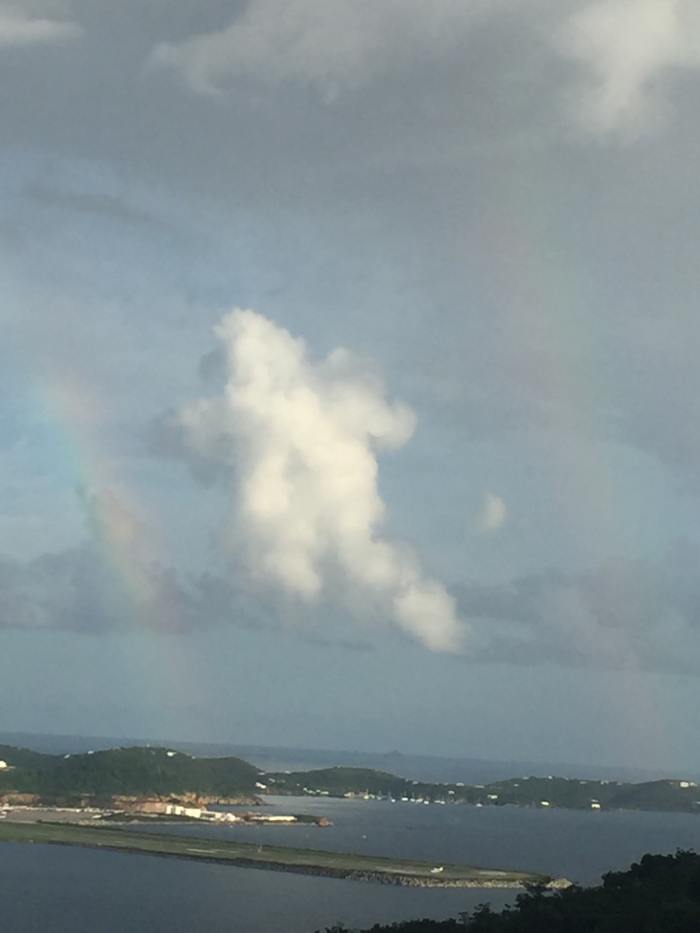 September 23, 2016 @ 5:20pm. St. Thomas USVI. This picture was taken over the Cyril R. King Airport. The caption is very interesting, It appears to be two rainbow with a cloud centered in a shape of a bear, perhaps or an angel.