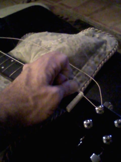 As you wind the string tight--I prefer not to use the winder for this--it's important to keep tension on the string, both on the peg side and on the bridge side.