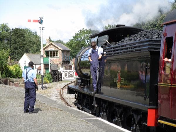 Headed for Redmire again, 65894 waits for the signalman at the crossing cabin to pull off the down starter