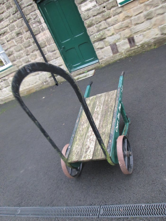 One of two platform luggage barrows that provide atmosphere for passengers awaiting their train from Redmire or Constable Burton