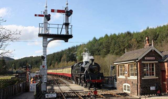 Preserved ex-LMS Fairburn 2-6-4 tank arrives at Levisham with a train for Grosmont on a bright, sunny afternoon