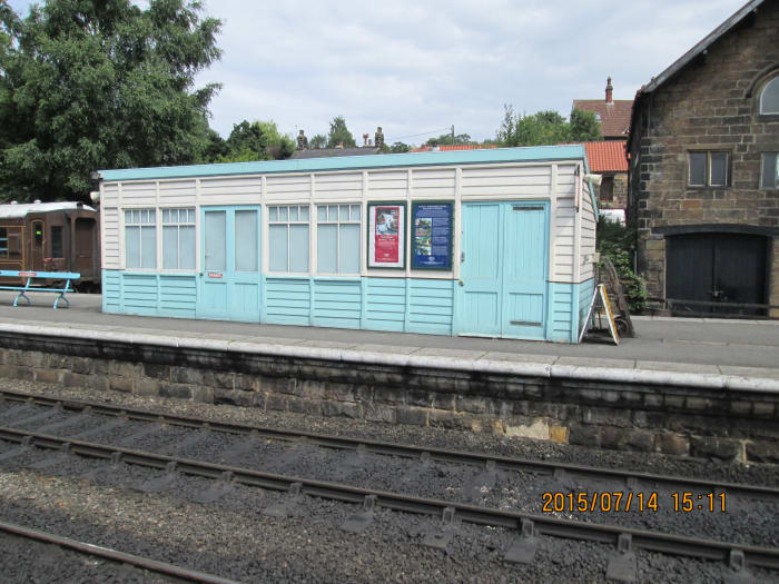 Enclosed platform shelter built in North Eastern Railway style on the former 'Up' platform, painted in British Railways' North Eastern Region blue and white as are the stairs on the signal cabin.