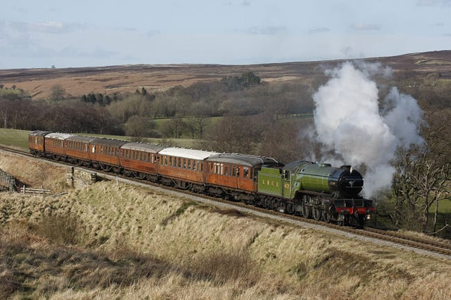Preserved Class V2 4771 'Green Arrow' takes a rake of restored LNERCA Gresley stock for a spin near the highest point of the NYMR line into Newtondale past Fylingdale's early warning station