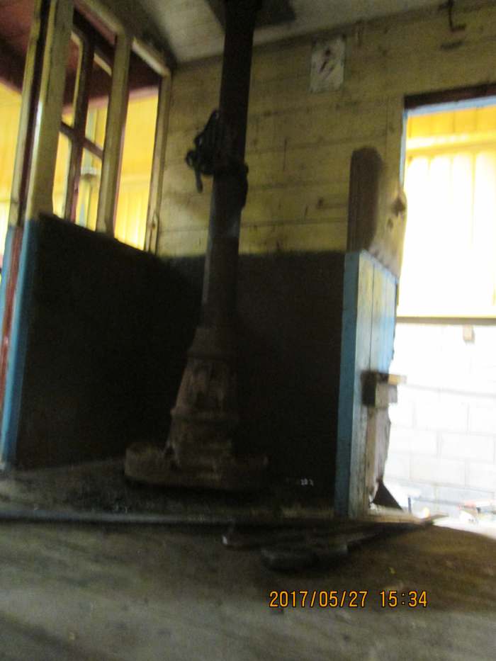 At the far side, by the door, is the stove that was meant to keep the guard warm in winter. Wooden, windowed duckets built centrally into the van body sides enabled the guard to see along his train of wagons