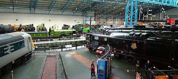 The NRM's Great Hall with locomotives of different vintage ranged around the 70' turntable (enlarged to accommodate York's fleet of Pacifics (4-6-2 Express Passenger locomotives, 11 in 1950, 7 in 1965)