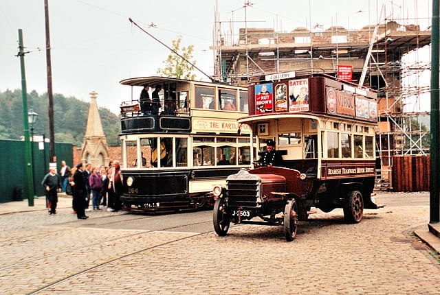 Beamish street scene with early double-decker ('knife-board') bus passing a double-decker tram. Double-decker trams were still fairly common on Britain's city and town streets until the mid-1950s