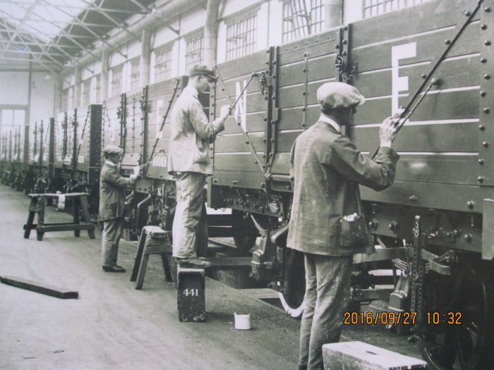 Wagons completed and painted, the time came for lettering & numbering. One man paints the 'N' in the left panel, his workmate adds the 'E'. 'NE' was the cypher for North Eastern and London & North Eastern Railway revenue earning wagons and vans