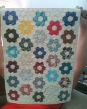 This particular miniature quilt took over 100 hours to hand piece; the hexagons are one inch wide.