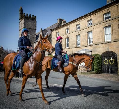 Racehorses return from exercises on the gallops by the Coverham road, seen here before reaching the market square (the photographer stood to the right of the road, near where the previous image was taken)