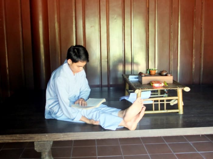 Student monk studying in one of the building which I suspect is also his lodging area, at Thien Mu pagoda