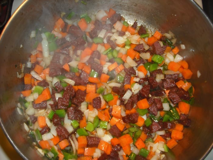 Add the onion, celery, carrots, garlic, salt and pepper. Sauté until the vegetables begin to soften, about 5 minutes.