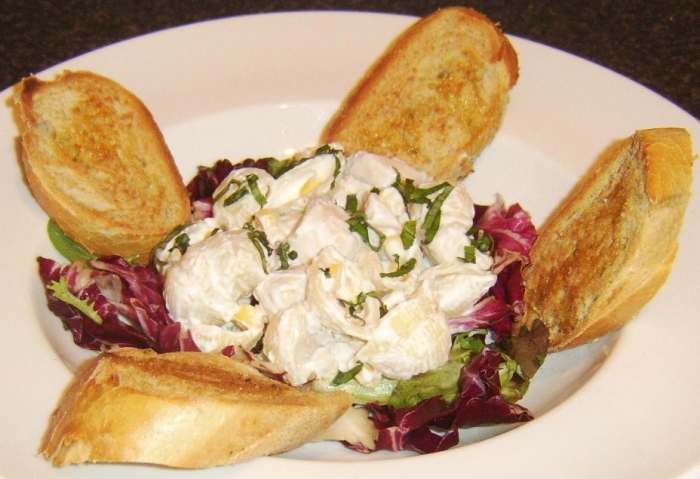 Cold chicken and conchiglie are made in to a sald with mayo and served on mixed salad leaves with bruschetta