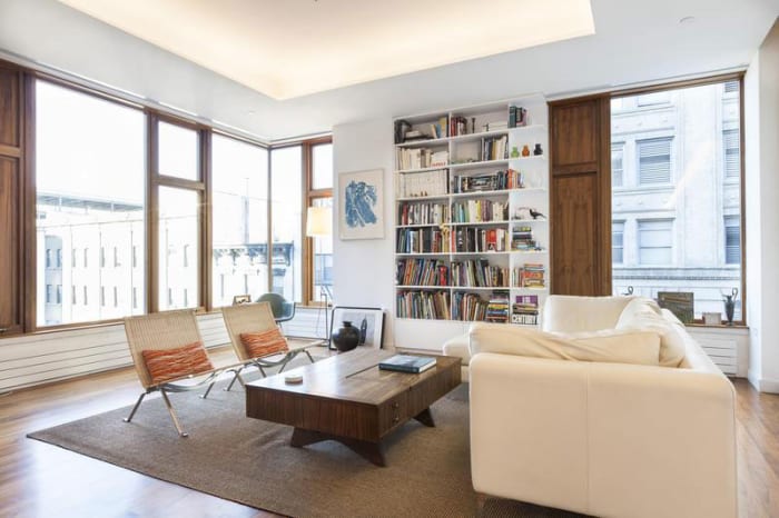 Drawing some attention and tying the bookshelf together, the furniture placed in front of it allows for plenty of circulation and ample amount of seating. ** Notice the windows.