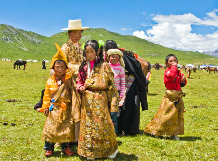 A traditional Tibetan family. Here, you can see the treeless landscape. Since there is permafrost trees and traditional burials don't thrive; further encouraging the long lived Tibetan Buddhist sky burial.