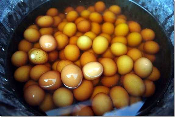 A virgin boy eggs cracked open (top); a young boy peeing in a bucket that will then be used to boil the eggs (middle); eggs simmering in human urine (bottom).