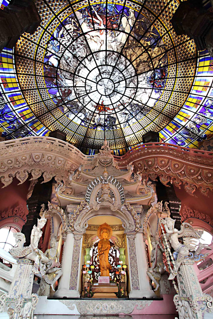 Inside the pedestal. The statue of Guanyin and the two staircases to either side. Above is the stained glass ceiling