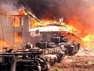 Officials in their tanks, watching the fire that broke out on the last day which earned the battle title, "The Waco Massacre."