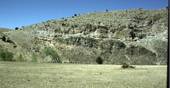 Overlying dark cliffs and ledges are from volcanic activity during the middle Tertiary period in Arizona