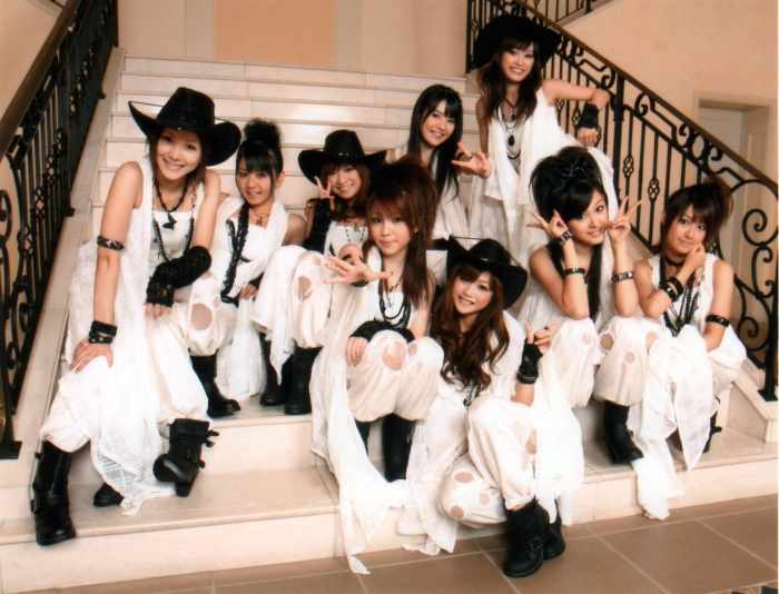 On the bottom of the stairs are members Reina Tanaka, Risa Niigaki, and Koharu Kusumi. Kusumi was the only member of the group's 7th generation.
