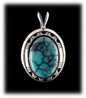 Blue spider web turquoise surrounded by stamped sterling silver. Spider web turquoise is very popular today.