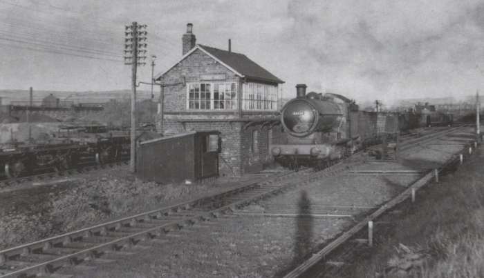 Unidentified Class Q6 0-8-0 brings a train of mineral wagons past Crag Hall signal cabin between Skinningrove Works and the Whitby-Loftus road