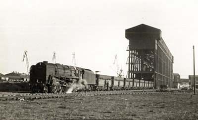 Unidentified Class 9F 2-10-0 at Tyne Dock iron ore terminal, 1960s. Also equipped with air compressors to operate the hopper doors, this class took over from the Class O1 2-8-0, hauling trains of nine hoppers to the O1's eight