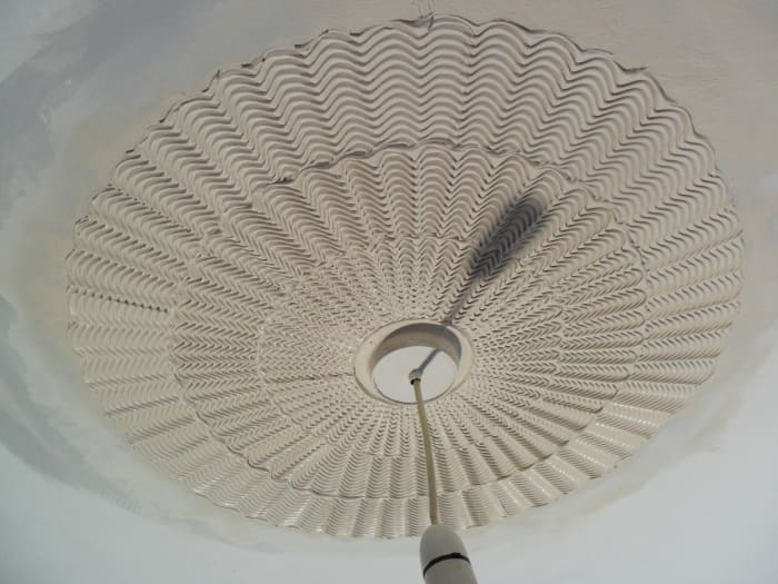 The Standard comb effect creates depth, and each comb overlaps the pattern just created as one works inwards, towards the center fitting, finally running a finger around the interior perimeter to clean off residue