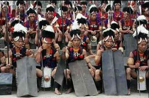 A group of cultural troupe With their shields, spears and adorned with traditional attire, before the folk dance begins at hornbill festival in Kohima.