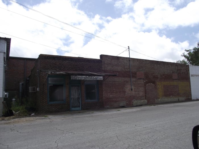 This is part of Walker Street in New Houlka. You can see where window and a door were once located on the building on the right.