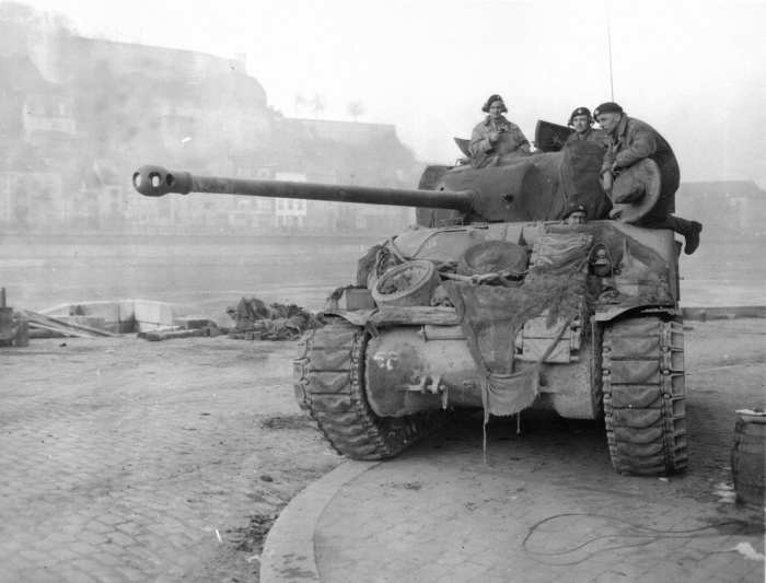 A British Sherman tank with 17 pound main gun used to battle heavier German tanks guarding a bridge over the Meuse River during the Battle of the Bulge.