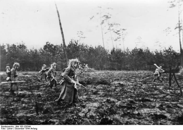 German in Volksgrenadiers (Peoples Infantry) in the Ardennes December 1944 armed with the new German Assault Rife and panzerfaust to help off-set their age and lack of experience in combat.