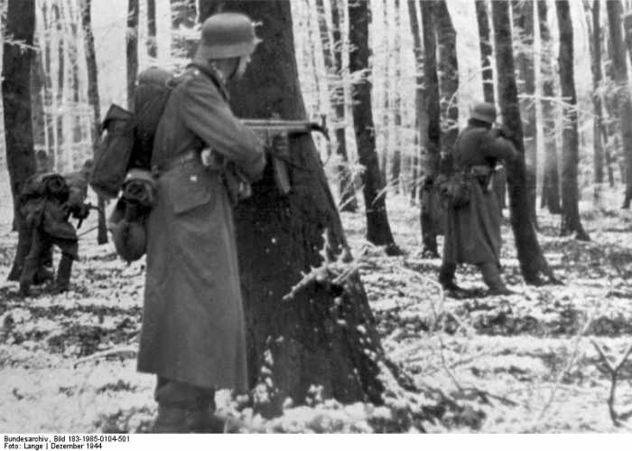 StG 44 equipped Volksgrenadiers fighting in the Ardennes. It was the first assault rifle used in combat. It was a combination of a sub machine gun and a semi automatic rifle.