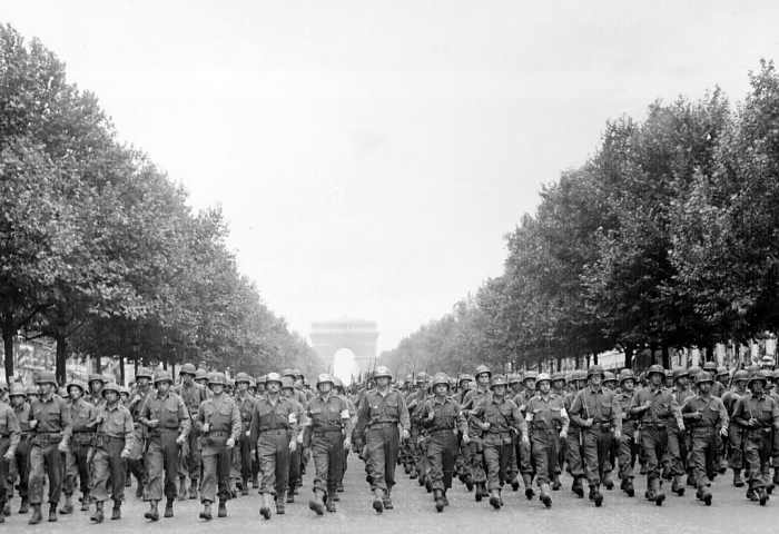 Men of the 28th Infantry Division march down the Champs Élysées in Paris straight to the battlefield August 29,1944. General Pershing gave it the name the "Iron Division" during the First World War.