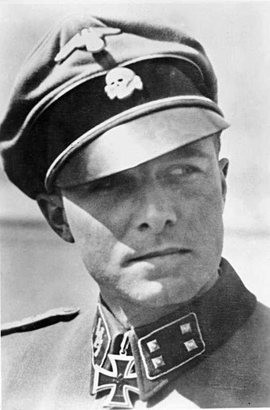 Colonel Jochim Peiper in his 1st SS Panzer Division "Leibstandarte" Adolf Hitler uniform. The Death's Head insignia on his cap signifies loyalty to the death for the Fuhrer Adolf Hitler. He spoke excellent English.